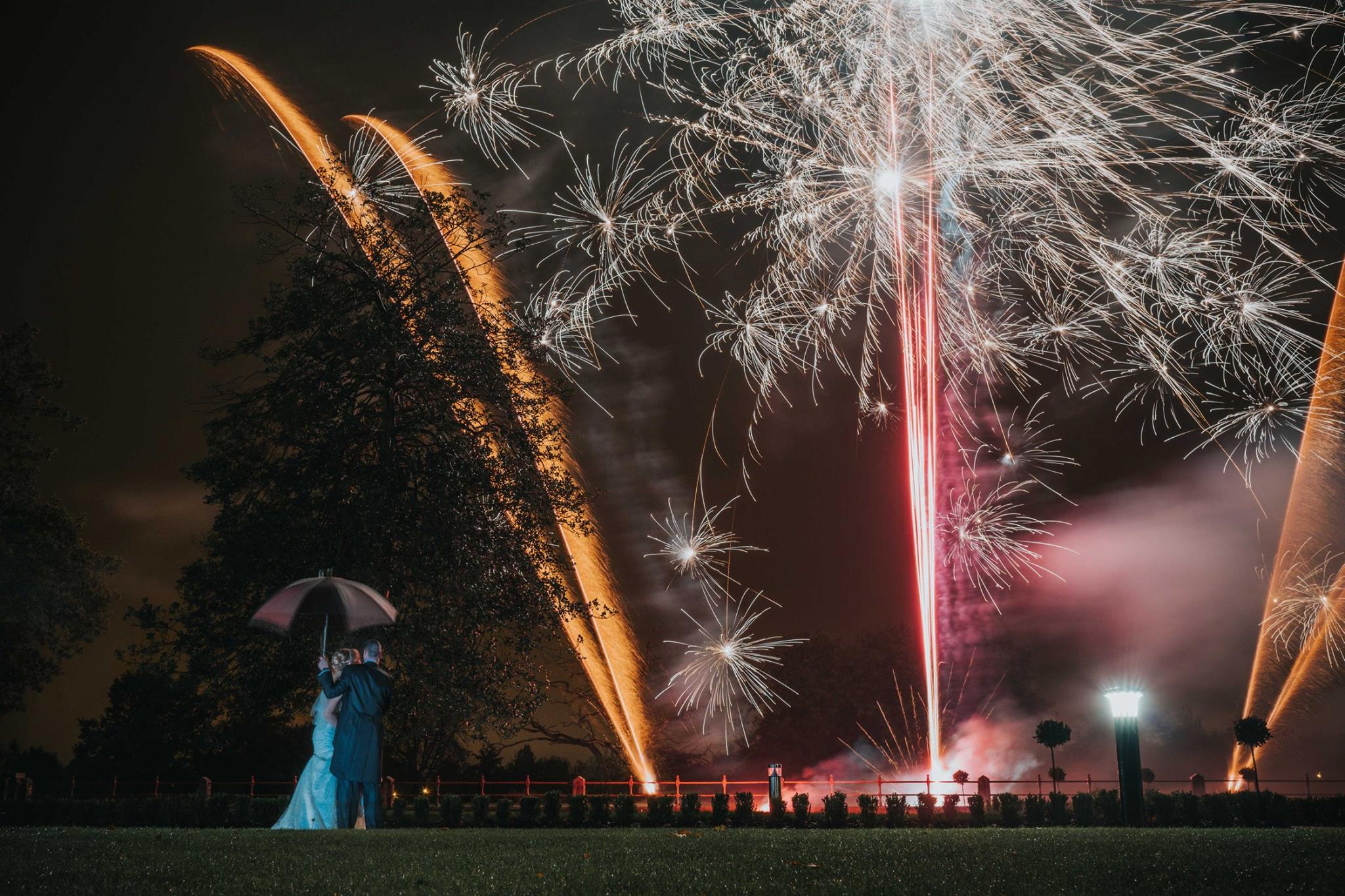 Wedding couple watching a spectacular fireworks display